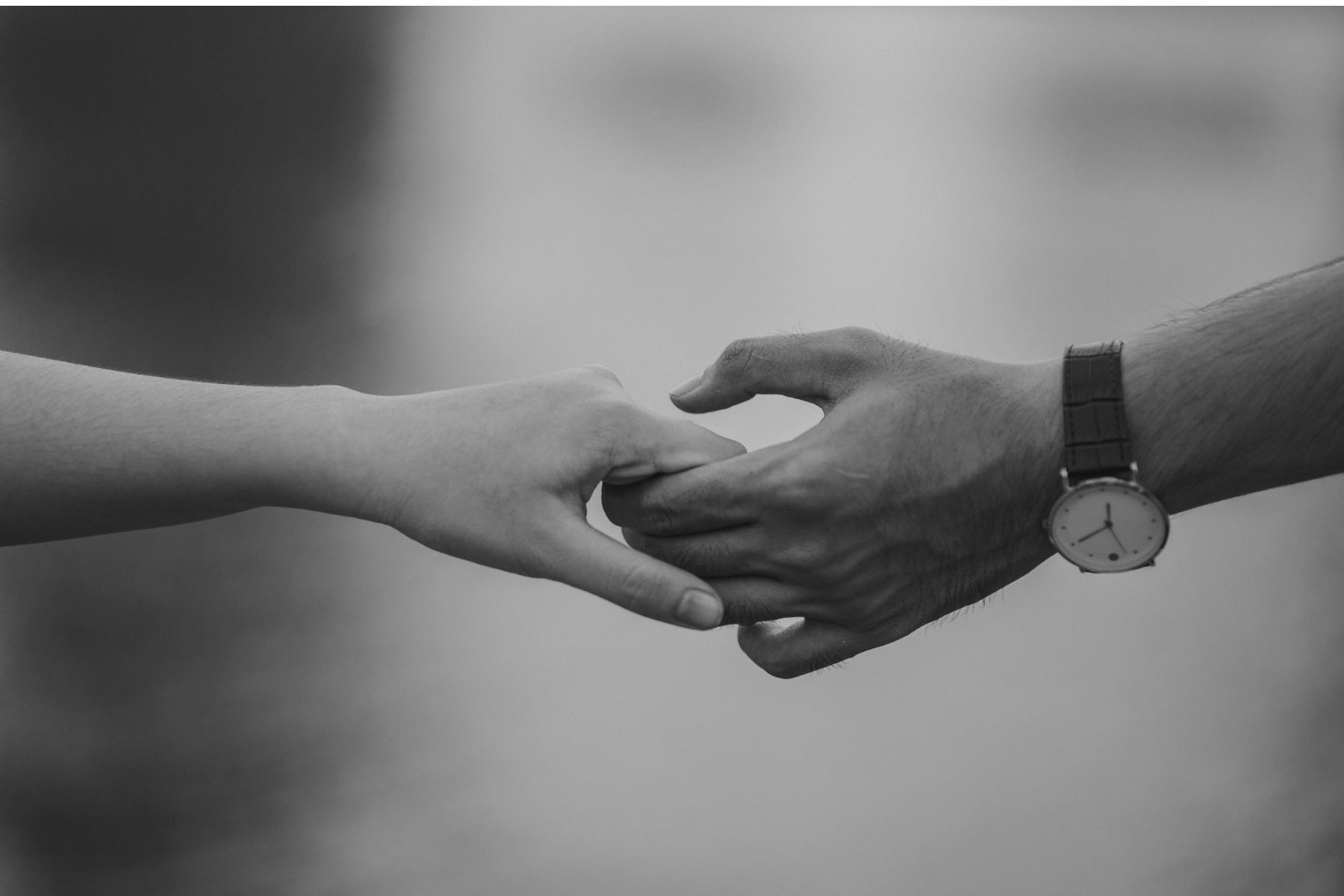 Compassion black and white image of someone reaching out to hold someone elses hand