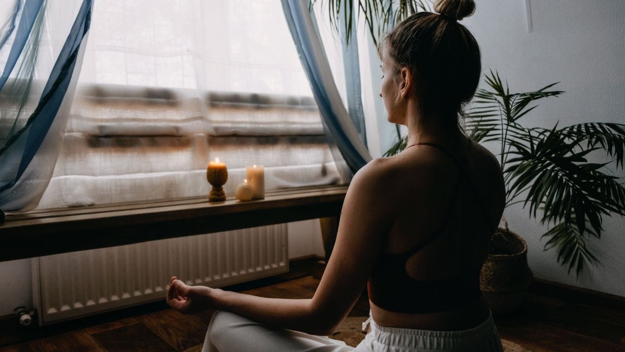 woman looking at a candle doing Focused Attention Meditation