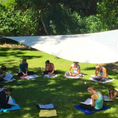 students studying in a circle in garden